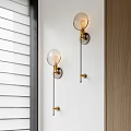 Modern Brass Wall Lamps With Spherical Glass Shade And Long Cord Switch On White Wall