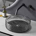 Diamond Textured Glass Washbasin With Black Faucet Green Plants Yellow Bottle And Round Mirror