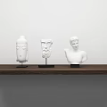 White Decorative Sculpture Ornament Set On Wooden Shelf With White Wall Background