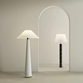 Modern Floor Lamps with White and Black Bases and White Shades in Arched Doorway Interior