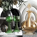 Elegant Green Wine Glasses And Golden Decanter In Stylish Table Setting With Books Floral Vase