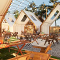 Outdoor Garden Landscape With Tent Like Canopies Wooden Tables Palm Trees And String Lights