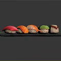 Assorted Fresh Sushi with Tuna Salmon Avocado on Black Slate Plate with Green Leaf