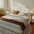 Double Bed With White Tufted Headboard Brown Blanket Checkered Pillow And Sunlit Cozy Bedroom