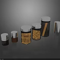Clear Glass Kitchen Storage Jars With Silver Lids Holding Spices And Dried Ingredients On Black Surface