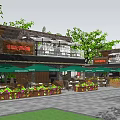 Commercial Street With Outdoor Dining Area Green Umbrellas And Flower Boxes