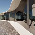 Modern Architectural Design With Curved Roof And Glass Facade In Open Plaza Space