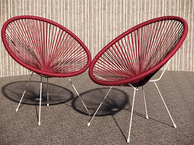 Pair of Modern Red Rattan Leisure Chairs With Metal Legs For Comfortable Indoor Living Space 3d model