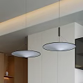 Circular Pendant Lights Hanging In Modern Interior With Wooden Cabinets And Open Shelves