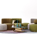 Modern Sectional Sofa Setup With Green Beige Ottomans Glass Coffee Table Decorative Items On Rug