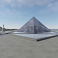 Main Glass Pyramid of Louvre with Smaller Pyramids in Open Square and Blue Sky