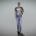 Man wearing gray T shirt and blue jeans with backpack standing against gray background