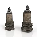 Two Ancient Stone Sculptures With Intricate Tower Shaped Design And Detailed Patterns