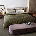 Double Bed With Green Checkered Quilt Wooden Headboard Purple Bench And Brown Chair