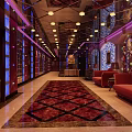 Luxurious Modern Elevator Hallway With Chandelier Lighting Red Carpet Red Sofas And Decorative Walls