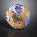 Hand Carved Circular Sculpture With Orange Blue Spiral Patterns And Hollow Center Design