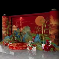 Traditional Chinese Banquet Hall Featuring Red Backdrop Round Moon Scrolls Rock Formations Bamboo And Flowers