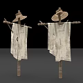 Two Scarecrows With Straw Hats And Worn Cloth On Wooden Poles
