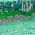 Garden Landscape With Steep Rocky Cliffs Green Vegetation And Lush Meadow