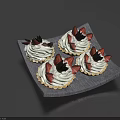 Four Delicious Cream Topped Tarts on Gray Tray With Chocolate Decorations and Black Fruits