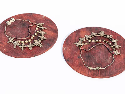 Gold Jewelry Pieces With Decorative Patterns And Beads On Round Wooden Trays 3d model