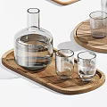 Transparent Glass Cups And Carafes Of Different Sizes On Wooden Trays For Drinking