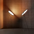 Modern Floor Lamps With Tripod Base And Round Shade Against Perforated Wall