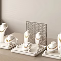 Elegant Gold Jewelry Display with White Stands Necklaces Earrings and Laser Cut Panel