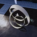Outdoor Landscape Sculpture with Metal Twisted Circular Rings in Water Pool and Modern Architecture Reflection