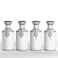 Elegant Perfume Cosmetics Collection With Four Black Glass Bottles And Brand Labels