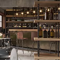 Industrial Bar Space With Drum Set Shelves Of Bottles Hanging Lights And Leather Stools