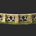 Ancient Stone Fence With Intricate Carvings And Green Grass In Garden