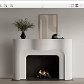 White Modern Fireplace With Green Plant Vase Artwork On Mantel And Burning Fire