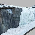 Garden Landscape With Thick Snow On Rocks And Cascading Ice Waterfall