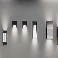 Modern Wall Sconces With Various Designs And Metal Finishes Displayed On Gray Wall