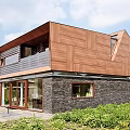 Modern Detached Villa Exterior With Wooden Facade Stone Wall Sloped Roof And Large Windows
