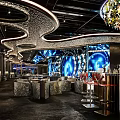 MOII Bar Interior With Black Brick Walls White Sculptures And Wavy Ceiling