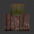 Green Grass Like Plants Growing In Red Rectangular Stone Planter With Mottled Texture