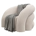 Plush Beige Single Sofa With Curved Design And Herringbone Throw Blanket