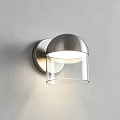 Modern Brushed Metal Wall Light with Transparent Glass Shade Mounted on Gray Wall Soft Illumination