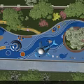 Park Landscape Featuring Curved Blue Water Play Slides Green Lawns And Pink Flowering Trees