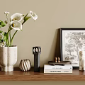 Decorative Ornament Collection On Wooden Shelf With Calla Lilies Books And Framed Art