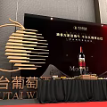 Elegant Banquet Hall Setup With Long Dining Tables Black Chairs And Red Stage Lighting