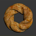 Golden Orange Ring Shaped Bread With Black Sesame Seeds And Twisted Texture