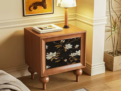 Wooden Bedside Table With Floral Pattern Drawer Lamp And Book Near Plant 3d model