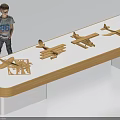 Toy Boy Doll Standing by Table with Four Wooden Airplane Models