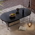 Black Oval Coffee Table With Drawer Fruit Tray Vase Open Book And Lamp On Rug