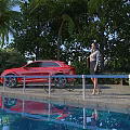 Red Car Parked By Swimming Pool With Palm Trees Green Plants And Water Reflection