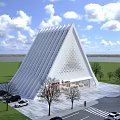 White Triangle Shaped Building With Hollowed Out Design And Red Signage Surrounded By Trees