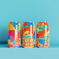 Three Colorful Canned Drinks with Vibrant Geometric Patterns on Blue Background